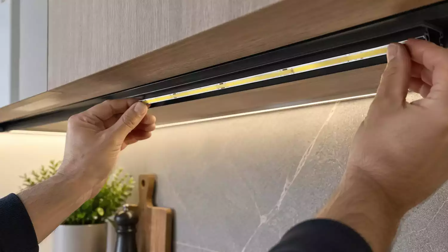 Instalador colocando una tira LED COB en un perfil de aluminio